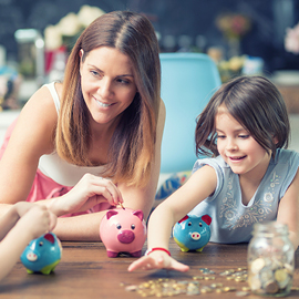 Mom and daughter with piggy banks