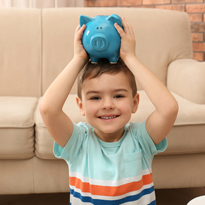 Little boy with a blue piggy bank on his head.