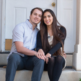 Young couple sitting on a door stoop