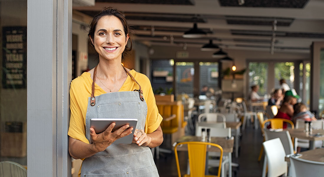 How to get a business loan - photo of woman restaurant owner in an apron