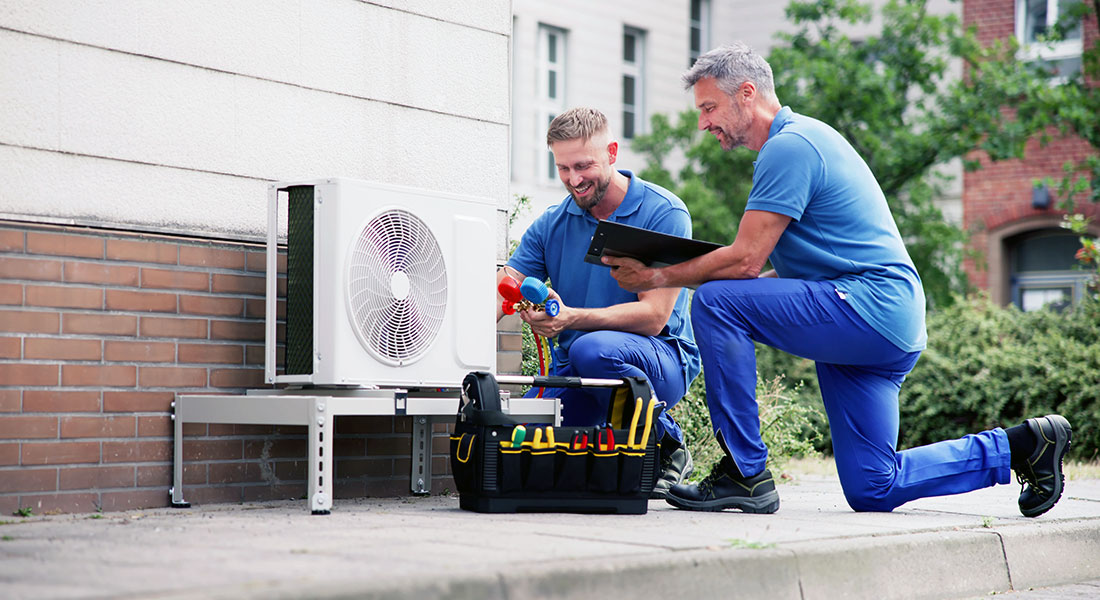How to get a business loan - photo of HVAC technicians and an AC