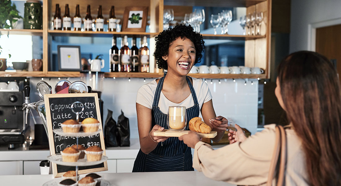 How to get a business loan - photo of a woman at a coffee shop serving a customer