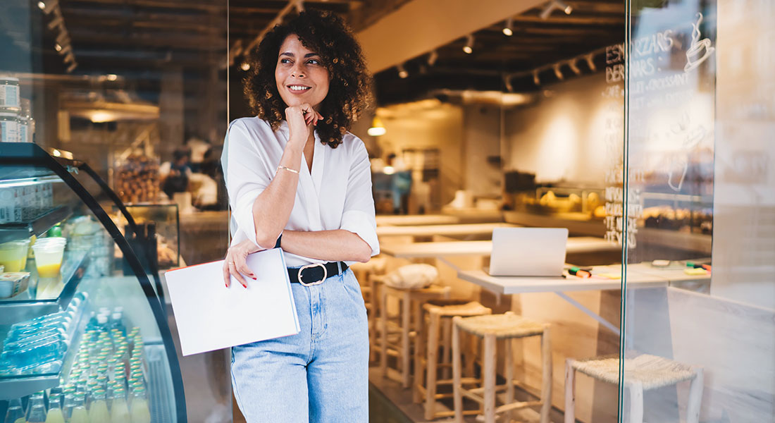 Franchise businesswoman standing by counter