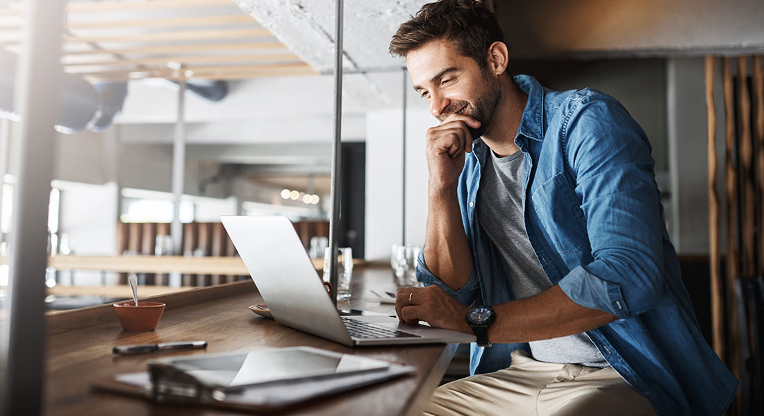 Business person using a franchise calculator on a laptop