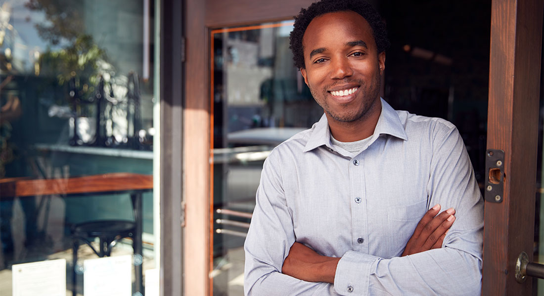 Franchise businessman standing by door