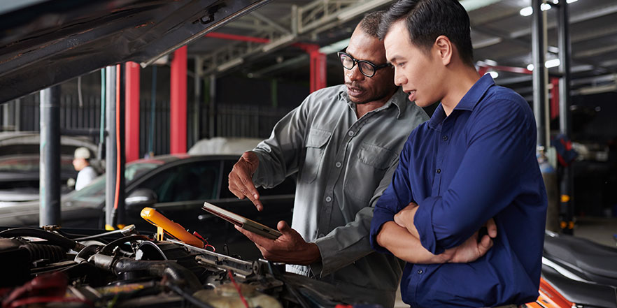 Automotive franchise business loan image of 2 people talking