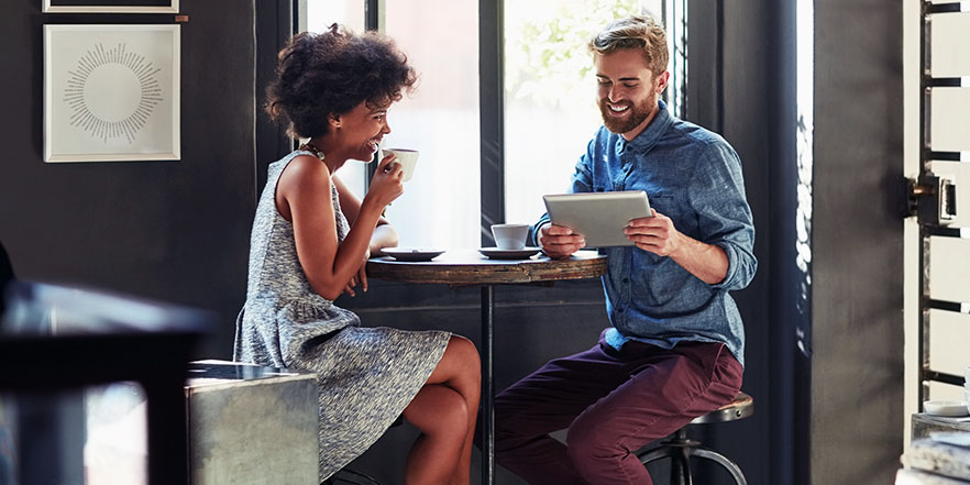 Franchise owners looking at tablet - Franchise Business Loans