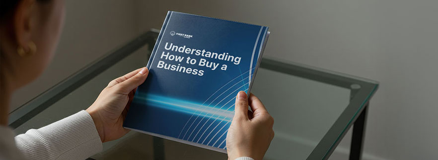 Person holding a book on how to buy a business - Buy a Business Loan
