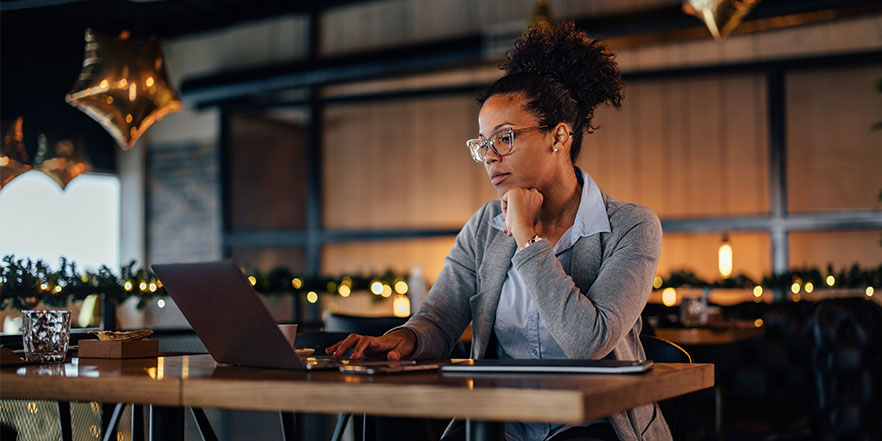 Businesswoman looking at laptop - Buy a Business Loan