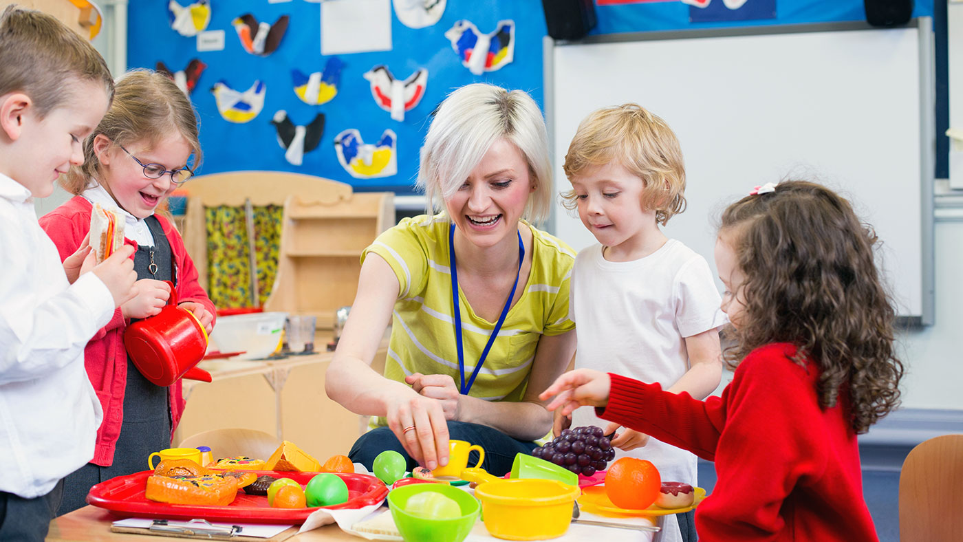 Childcare worker playing with children - Childcare Franchise Loans