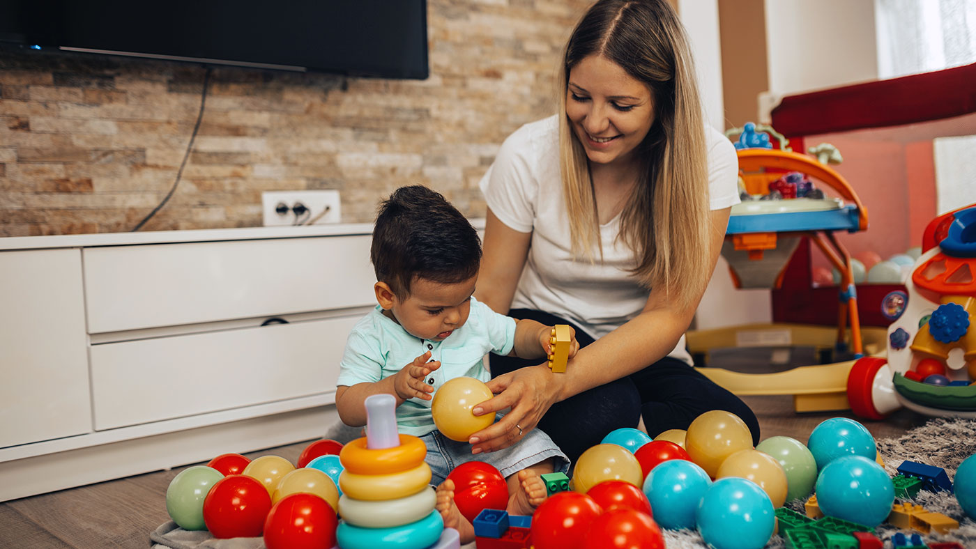 Childcare worker playing with child - Childcare Franchise Loans