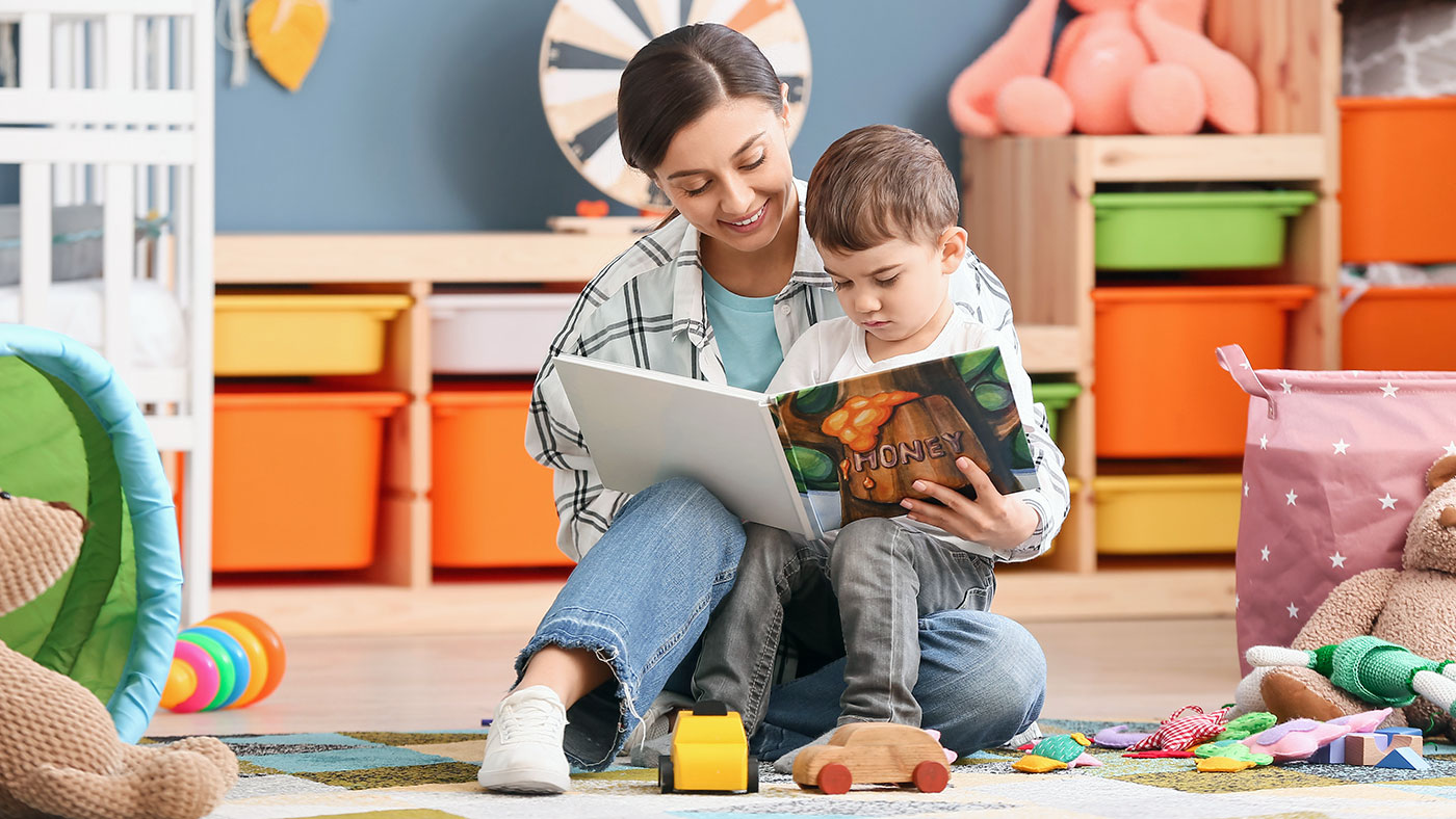 Childcare worker reading to child - Childcare Franchise Loans