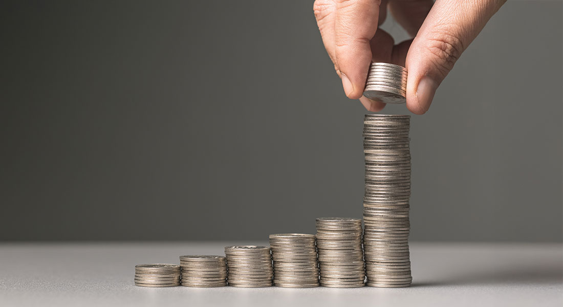Stack of coins showing increasing interest - Compound Interest Calculator