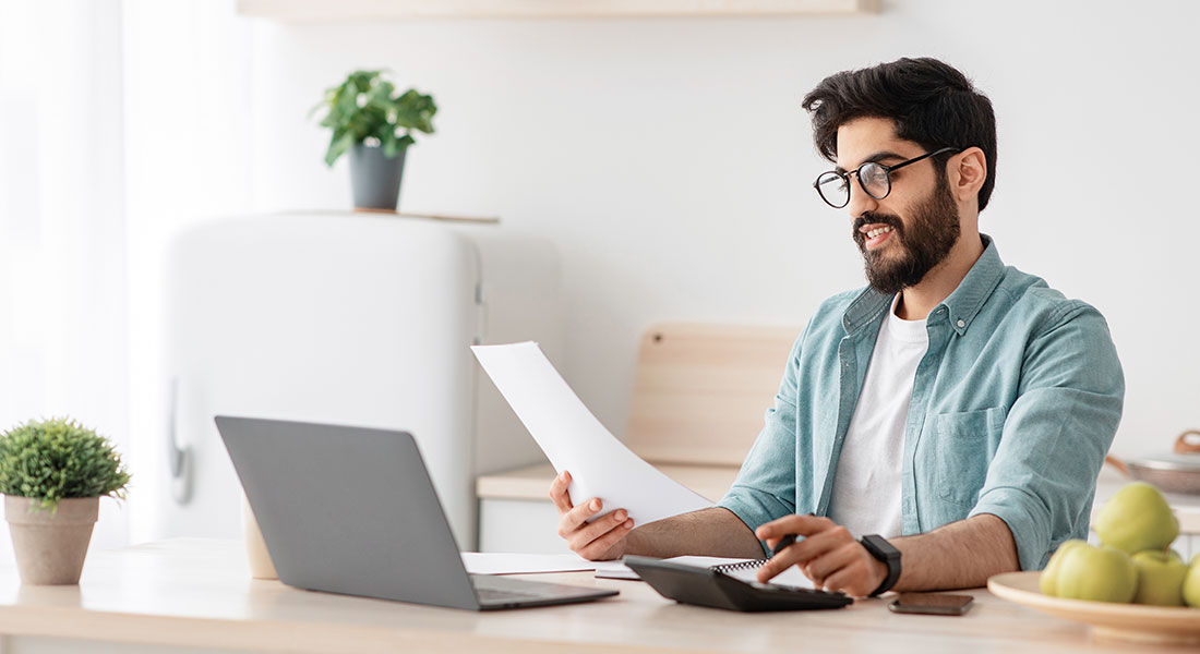 Man using a calculator - Compound Interest Calculator