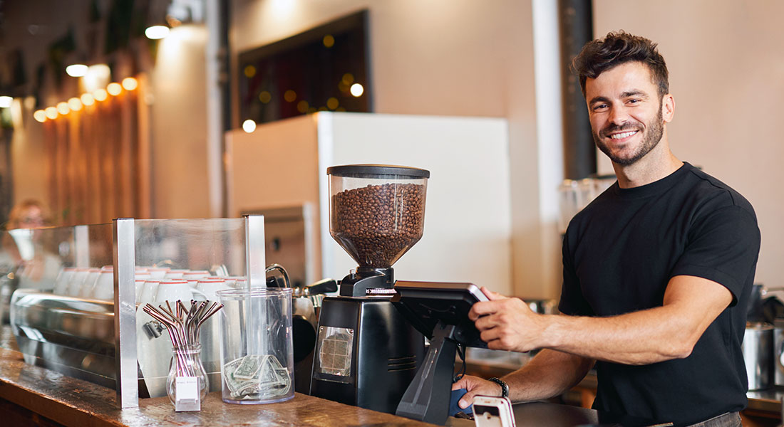 Man working in a coffee franchise - Franchise Advantages and Disadvantages