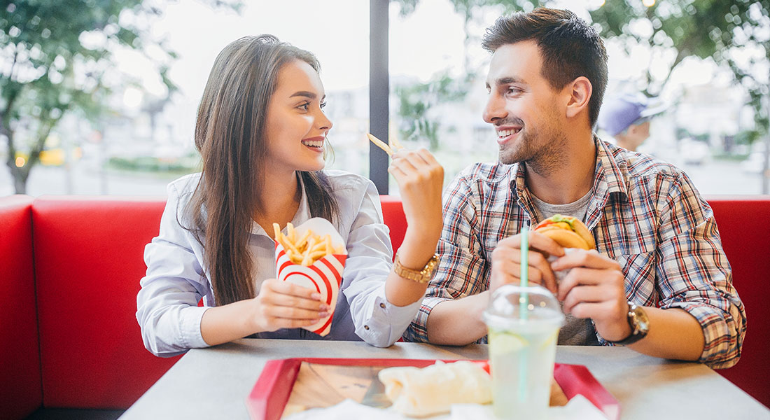 Couple eating at a burger franchise - How to Buy a Franchise Book