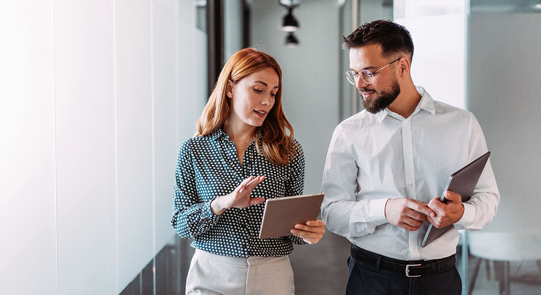 Business owners discussing in hallway - SBA 7a Business Loan