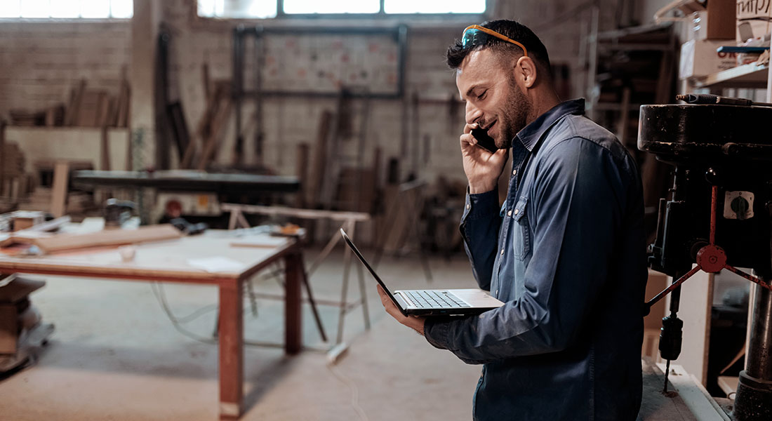 Business owner talking on phone - SBA 7a Business Loan