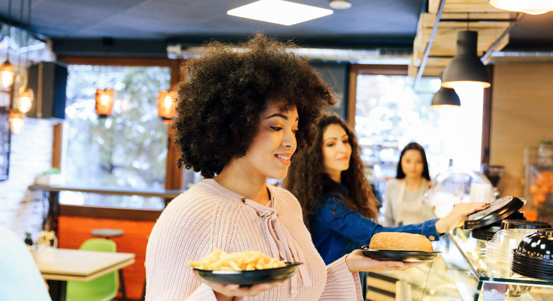 Customer getting meal from fast food counter - Franchise Model